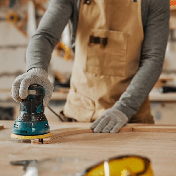Man sanding wood plank